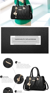 Detail of black pebbled PU leather tote with gold floral charm and metallic ring