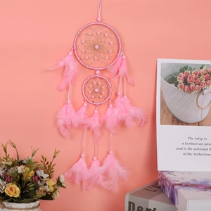 Detailed view of the pink double ring dreamcatcher with soft feathers and delicate beads