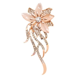 Macro view of rose gold flower brooch with pink opal petals and cubic zirconia detail