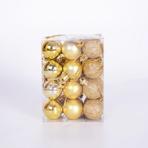 Macro shot of 24 gold Christmas balls in matte, glossy, and glitter finishes in a box