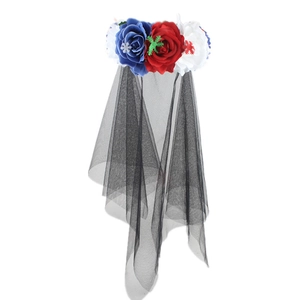Detail of red white and blue flowers with snowflake accents and black tulle veil on headband