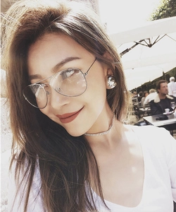 Outdoor lifestyle shot of a woman wearing gold metal pilot-style eyewear frames