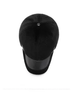 Top view of winter baseball cap showing black faux fur and matte leather texture