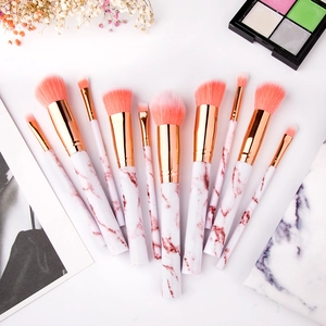 Detail of 10-piece marble texture makeup brush set with gold ferrules and pink bristles