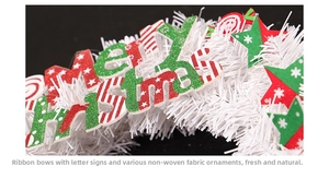 Detail of Christmas wreath with white mesh, glitter Merry Christmas sign and star charms