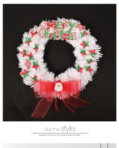 Close-up of white mesh Christmas wreath with Merry Christmas sign and red mesh bow