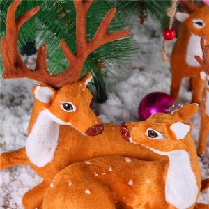 Realistic brown and white reindeer figurines with antlers for Christmas table decor