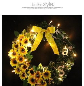 Detail of sunflower wreath with warm LED lights and a yellow polka dot bow decoration