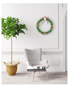 Green PVC Christmas wreath with Santa Claus and gift boxes hanging on a white wall