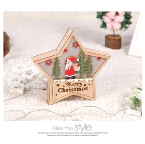 Macro detail of wooden star-shaped Christmas ornament with Santa and LED light