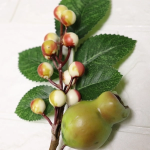 Artificial Christmas berry branch with green leaves and red-yellow gradient fruit berries