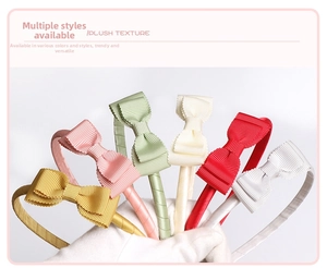 Detailed view of six colorful ribbed fabric bow headbands held by a gloved hand