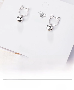 Detailed view of silver cat studs with bells on a display card marked Made in Korea