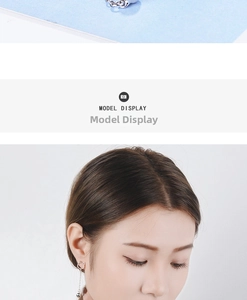 Detailed view of silver cat ear stud earrings with long tassel chain and bell charm