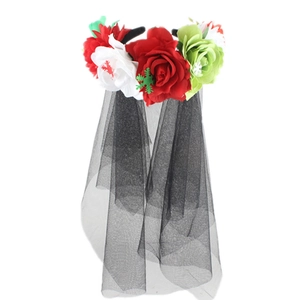 Detail of Halloween flower headband with red white and green blooms and black mesh veil