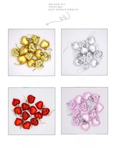Detail view of heart-shaped Christmas ornaments in gold, silver, red and pink finishes