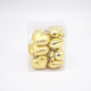 Detailed view of 12-piece golden heart ornaments in box for Christmas and holiday decor