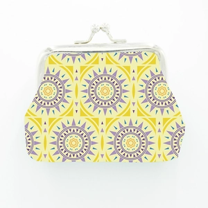 Detail of vintage Moroccan coin purse with yellow geometric sun pattern and metal clasp