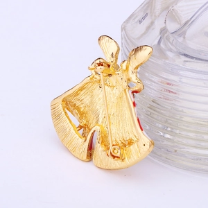 Close-up of the gold-plated bell brooch back showing the secure pin and metal texture