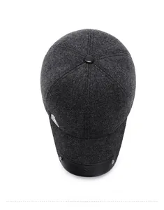 Detailed top view of grey wool baseball cap with black leather brim and rivet detail