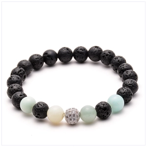 Macro shot of 8mm volcanic stone beads with micro-paved zircon ball on elastic bracelet