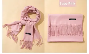 Detail of baby pink cashmere scarf showing soft texture and delicate fringe tassels