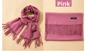 Detail view of dusty pink cashmere scarf with tassels showing texture and draped style