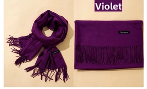 Detail of soft violet cashmere scarf showing thick fabric texture and long tassels