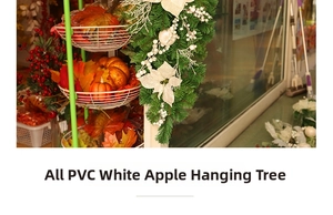 Detail of Christmas teardrop swag with white apples, flowers, and silver berries on PVC branches