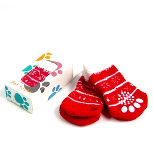 Close-up of red and white striped anti-slip pet socks with cute paw print packaging
