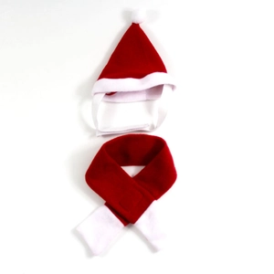 Detail of red and white plush Christmas pet hat and scarf set on white background