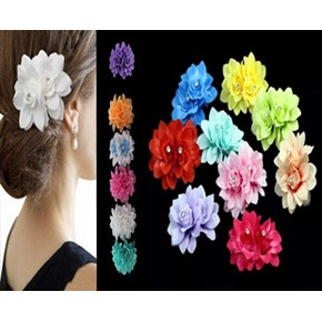 Macro detail showing colorful feather fascinator headbands with pearl and rhinestone accents