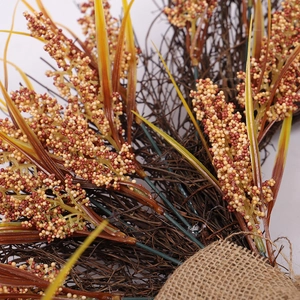 Thanksgiving harvest wreath with wheat ears, colorful berries and burlap decoration