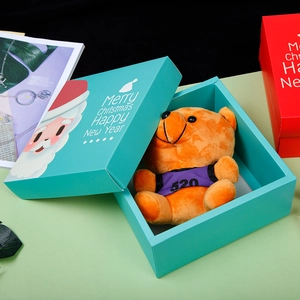 Teal Christmas gift box with orange teddy bear and Merry Christmas greetings