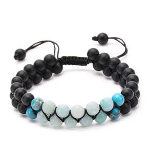 Detail of double-layer woven beaded bracelet with matte black and blue stones and adjustable cord