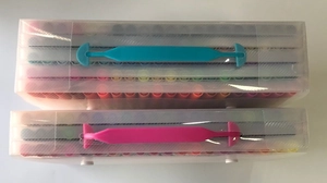 Dual-tip art markers in clear storage boxes with blue and pink silicone handles