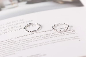 Detailed view of silver minimalist wavy and twisted stackable open rings for women