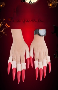Detailed view of Halloween cosplay finger claws with long red nails and skin texture