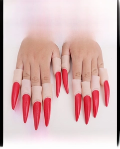 Detail of red vampire finger claws for Halloween costumes with long sharp nail design
