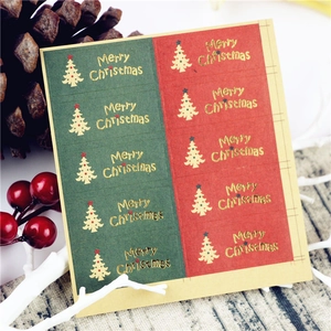 Detail of red and green Merry Christmas tree sealing stickers with gold foil stamping
