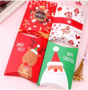 Macro detail of four festive pillow-shaped gift boxes with various holiday theme patterns
