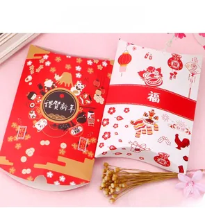Close-up of pillow-shaped holiday gift boxes for candy with festive lion dance patterns