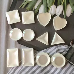 Close-up of assorted mini ceramic sauce dishes in geometric shapes for home dining