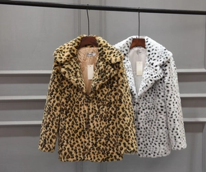 Detailed close-up of brown and white leopard print faux fur coat with fluffy texture