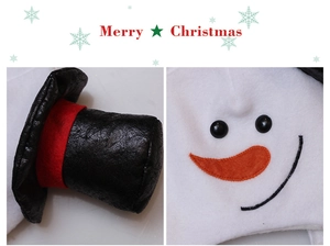 Detail of Christmas snowman hat with black felt cap, orange carrot nose and embroidery