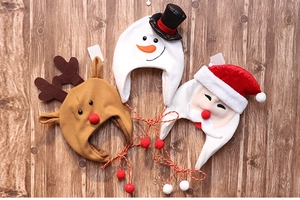 Detailed flat lay of felt Christmas hats featuring snowman, reindeer, and Santa designs