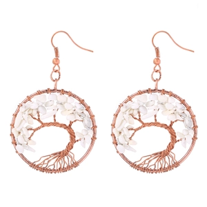 Detail of handmade wire-wrapped tree of life earrings with white natural crystal chips