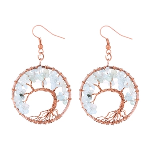 Macro view of handmade wire-wrapped tree of life earrings with blue natural crystals