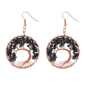 Detail of handmade copper wire tree of life earrings with black natural crystal stones