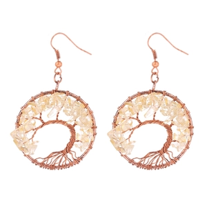 Detail of handmade Tree of Life earrings with bronze wire and yellow crystal beads